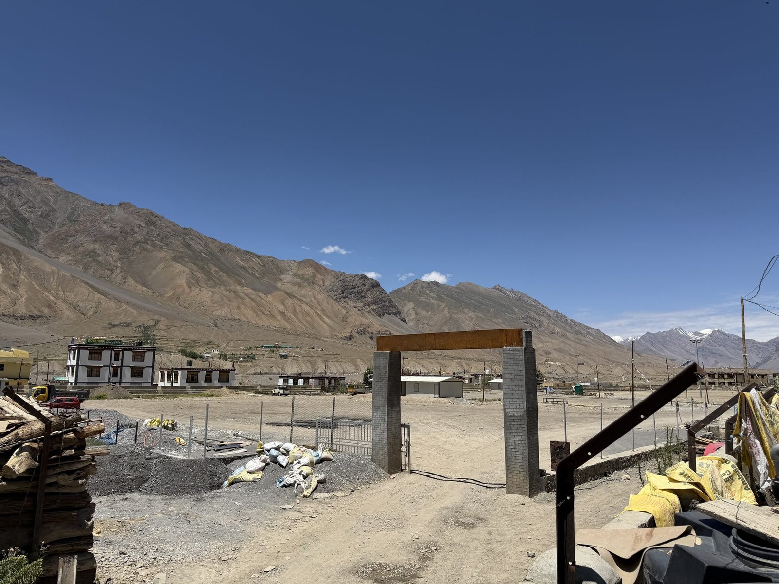 Property gate and grounds at 7 Pines Homestay, with Spiti mountains behind